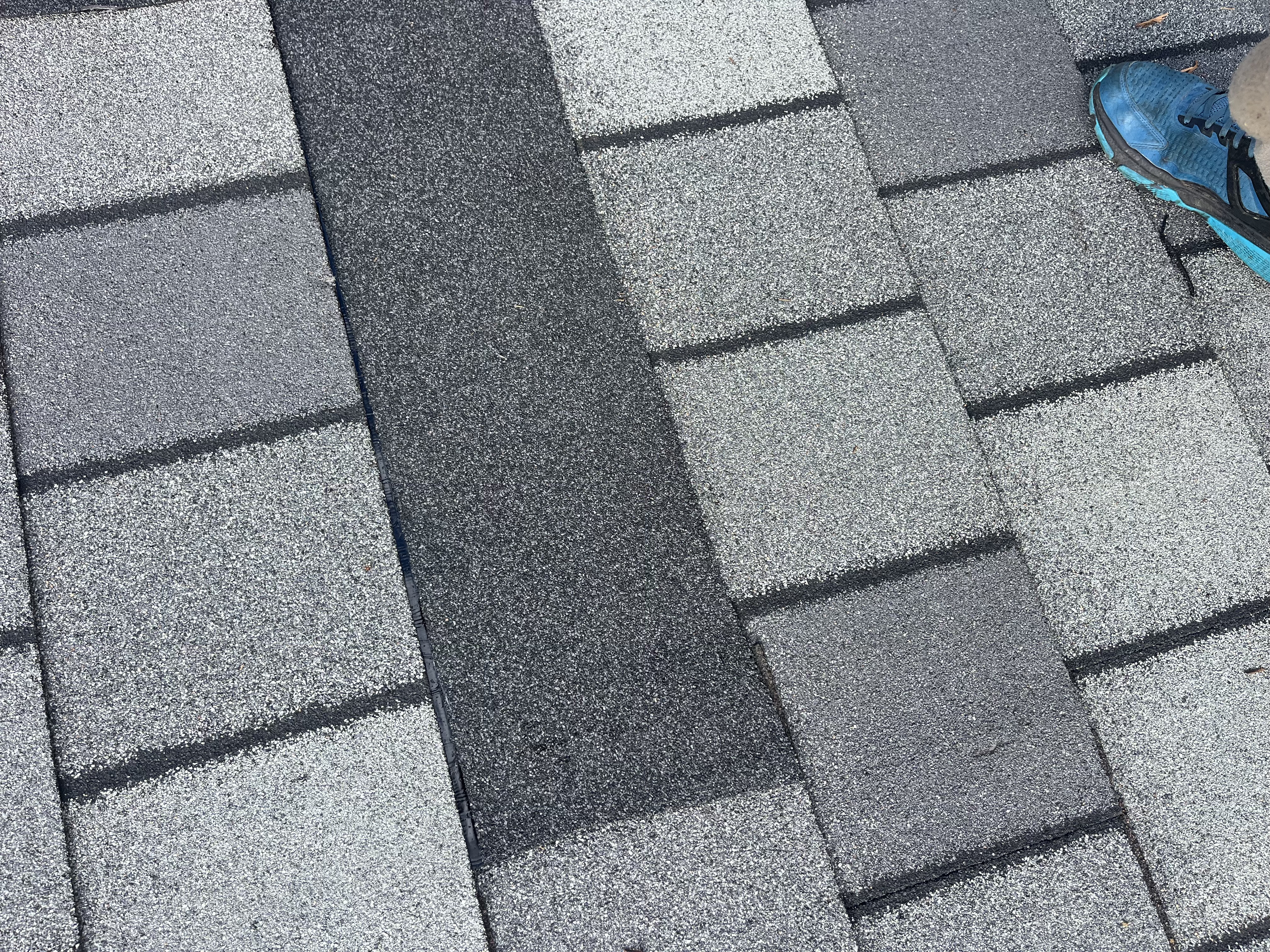 Repaired shingle courses blended into the existing roof
