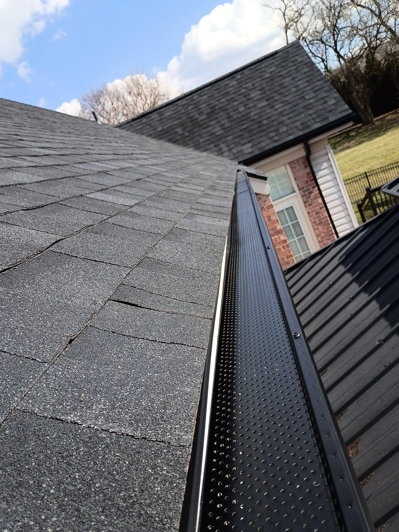 Gutter guards installed along a residential roofline