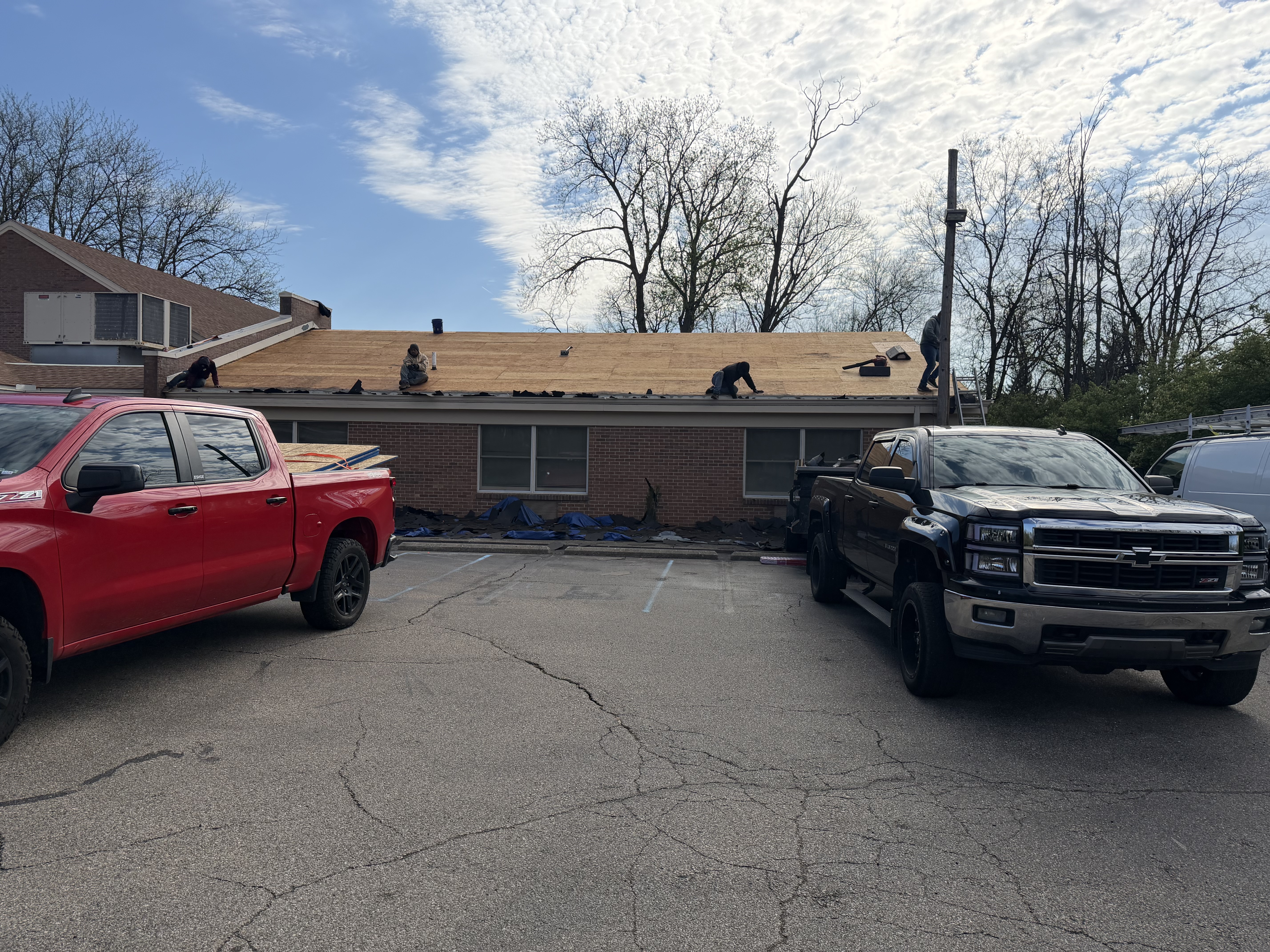 Roof replacement in progress with new materials staged on the deck