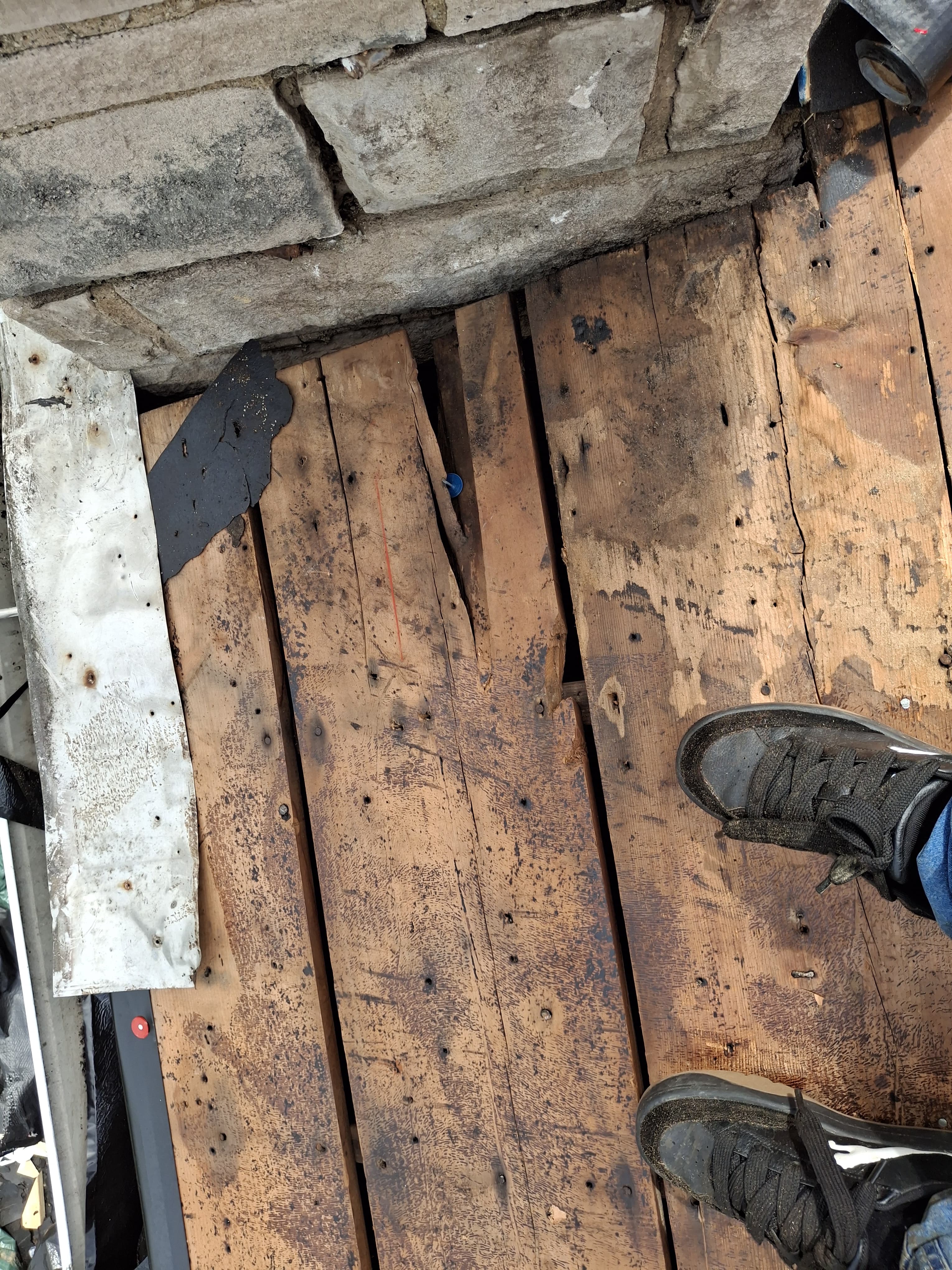 Damaged roof decking exposed during an emergency roof repair