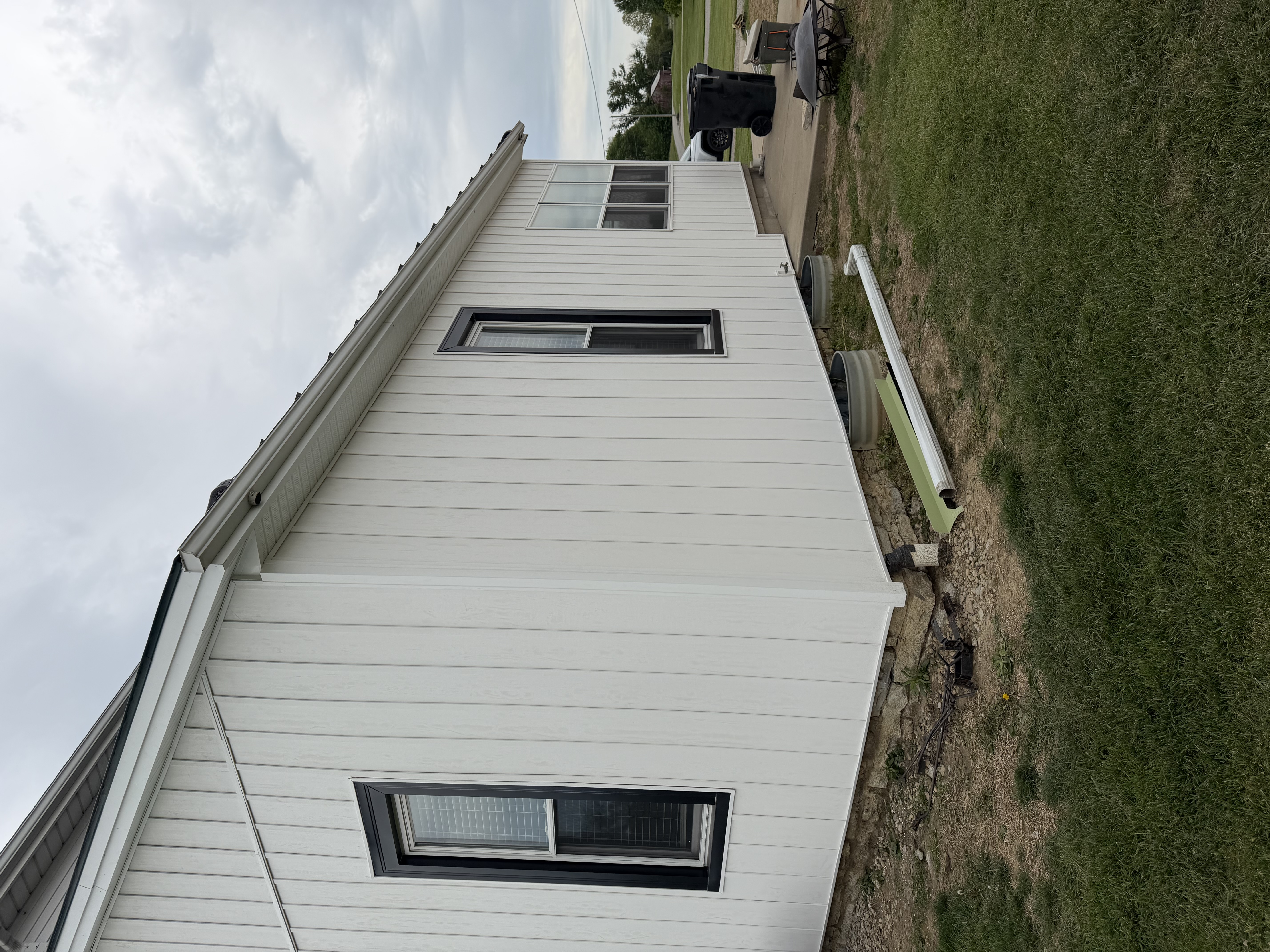 White vertical siding on a residential side wall after repair work