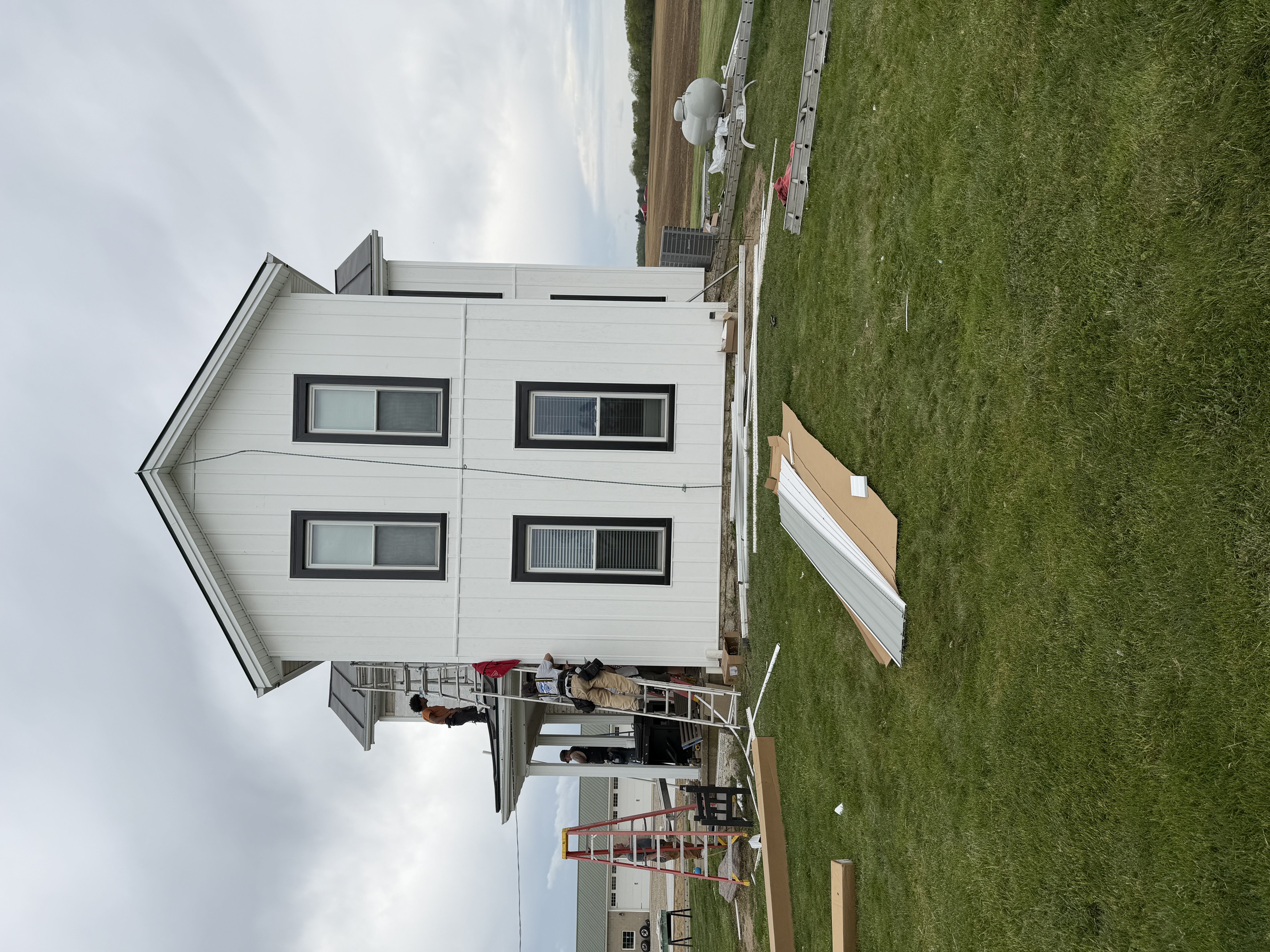 White siding replacement on a two-story home