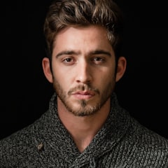 Man with a beard wearing a gray knit sweater