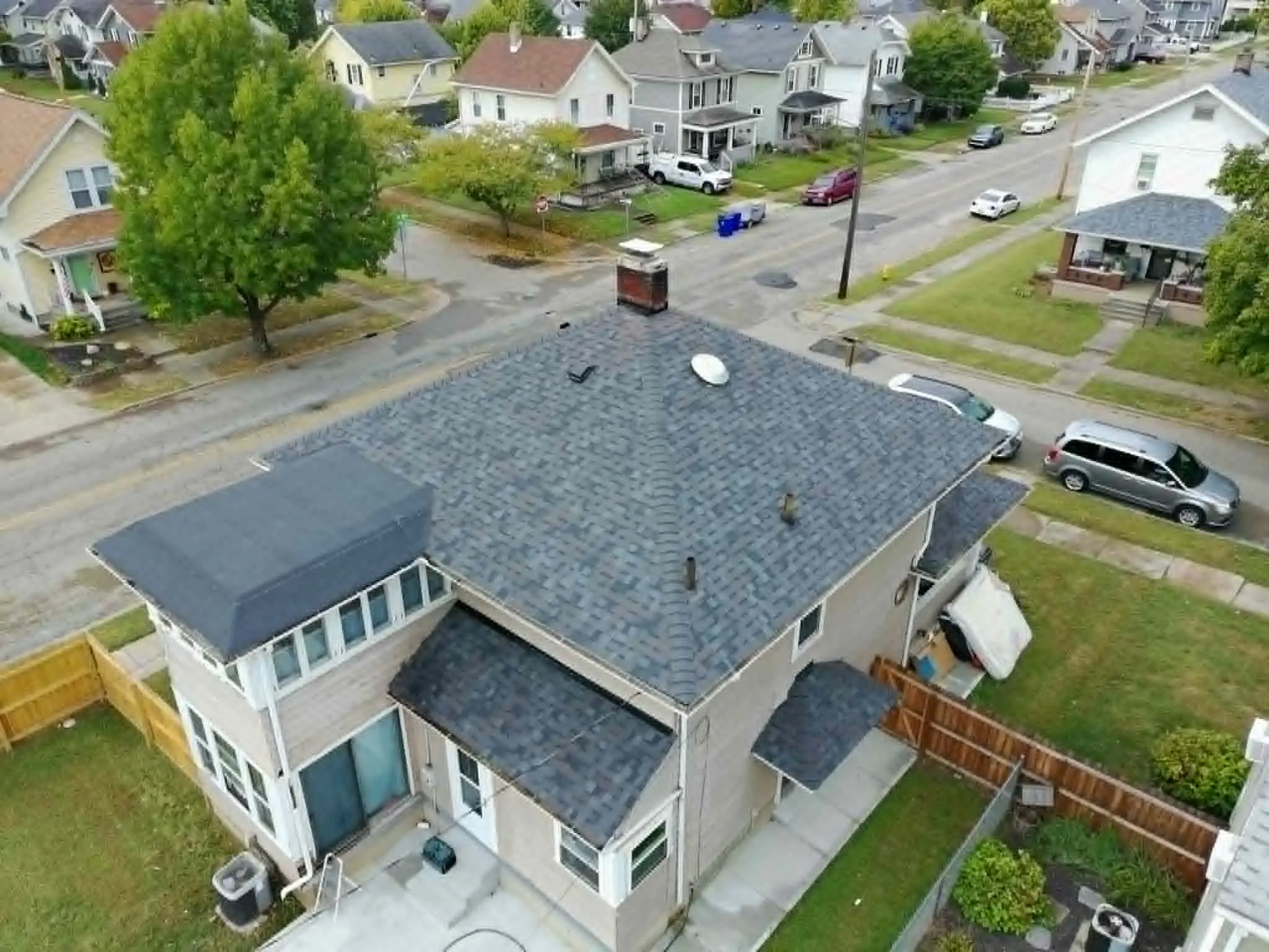 Completed dimensional shingle roof with clean ridge lines and uniform color