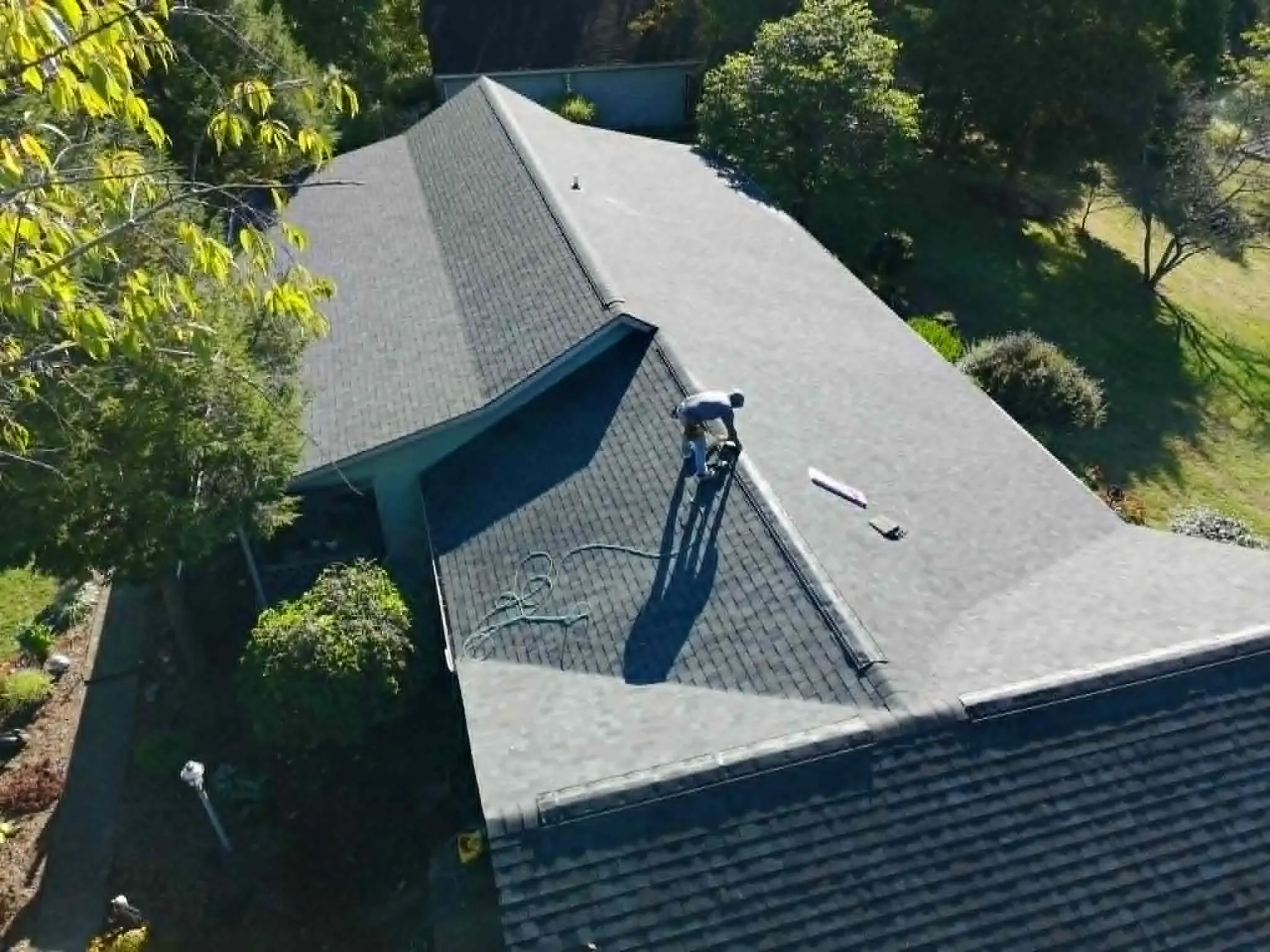 Dominion Roofing crew installing architectural asphalt shingles