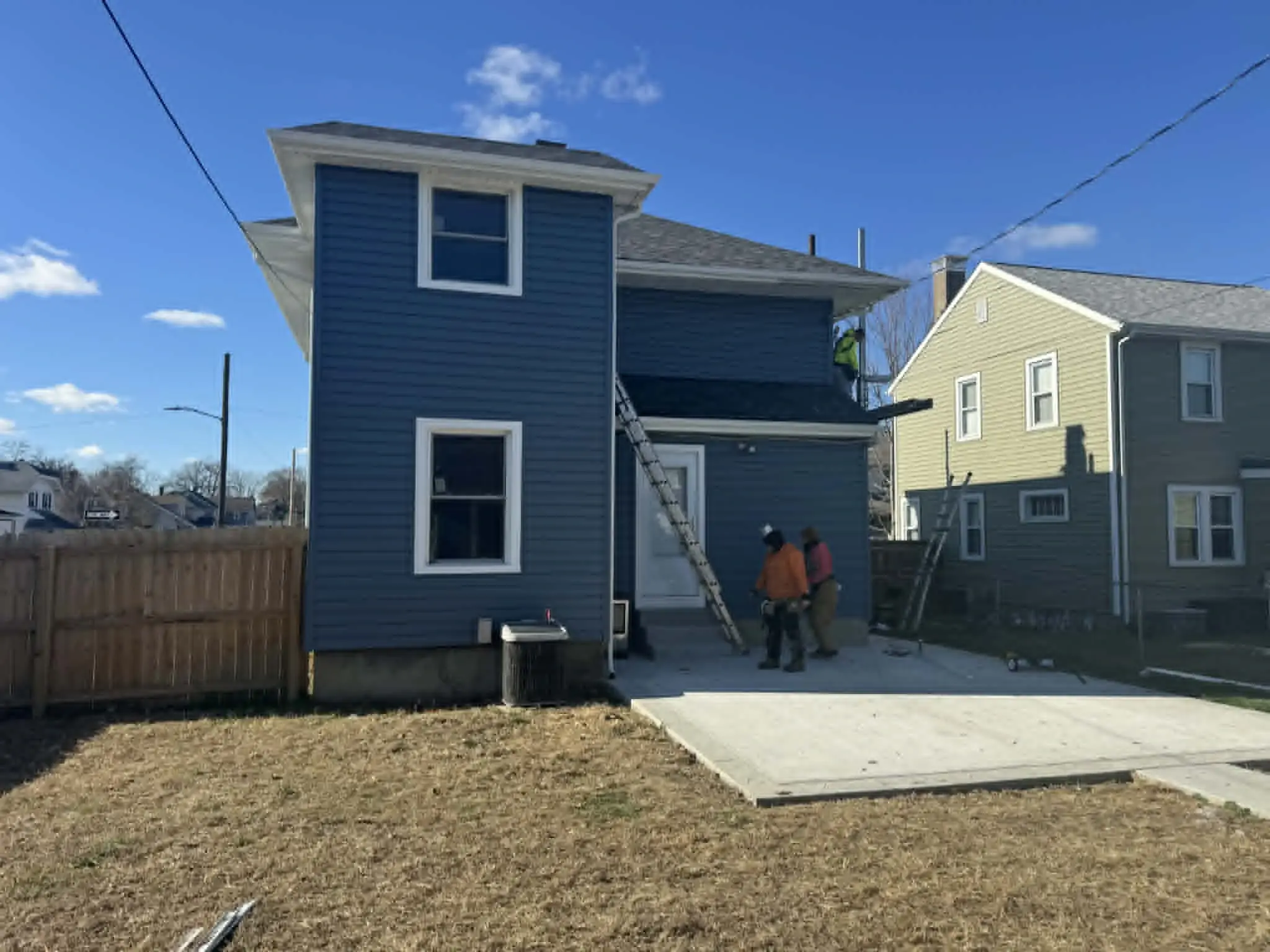 Ohio home with modern slate blue siding and white trim accents