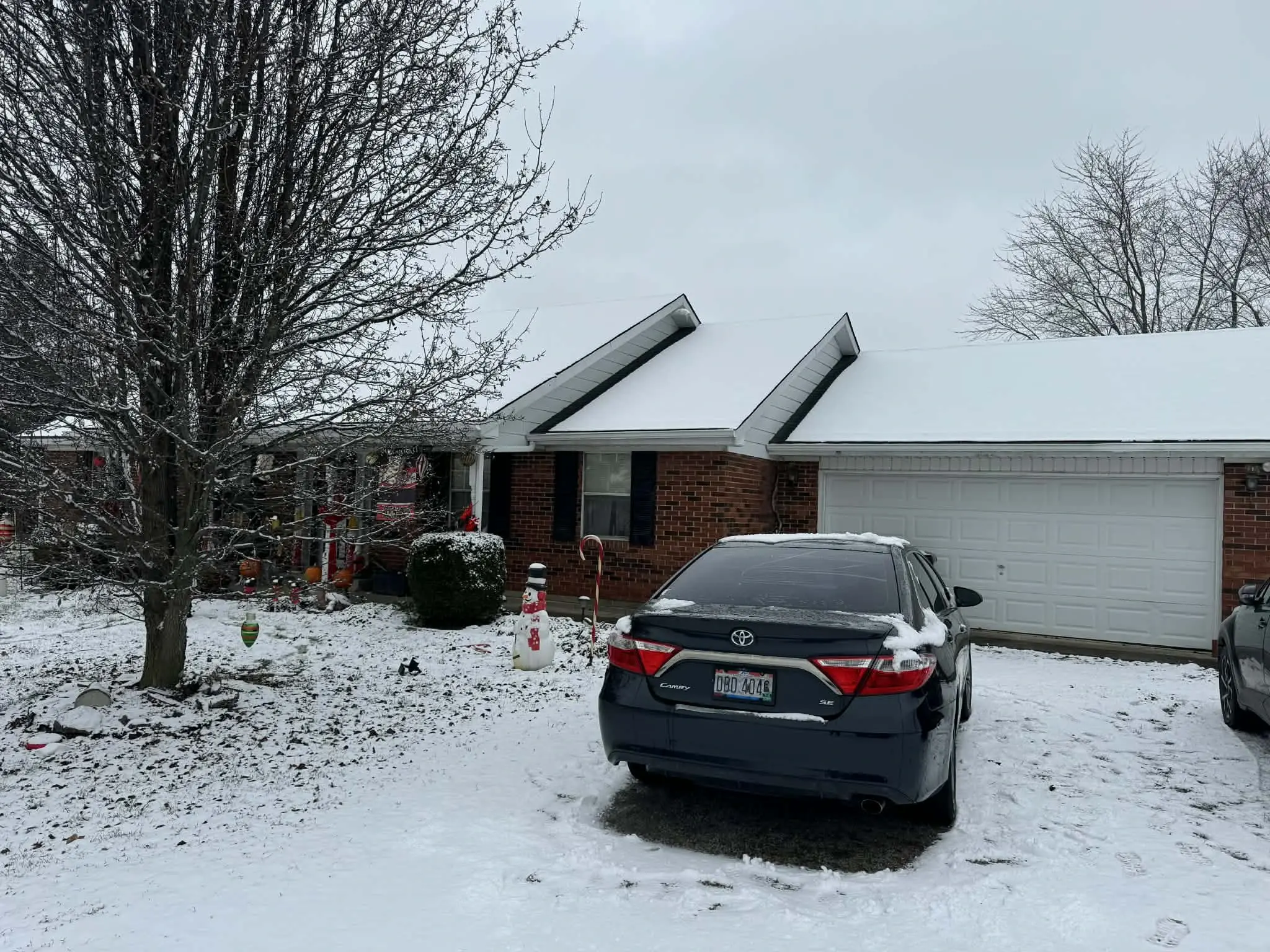 Roof replacement work staged during Ohio winter with snow on surrounding ground