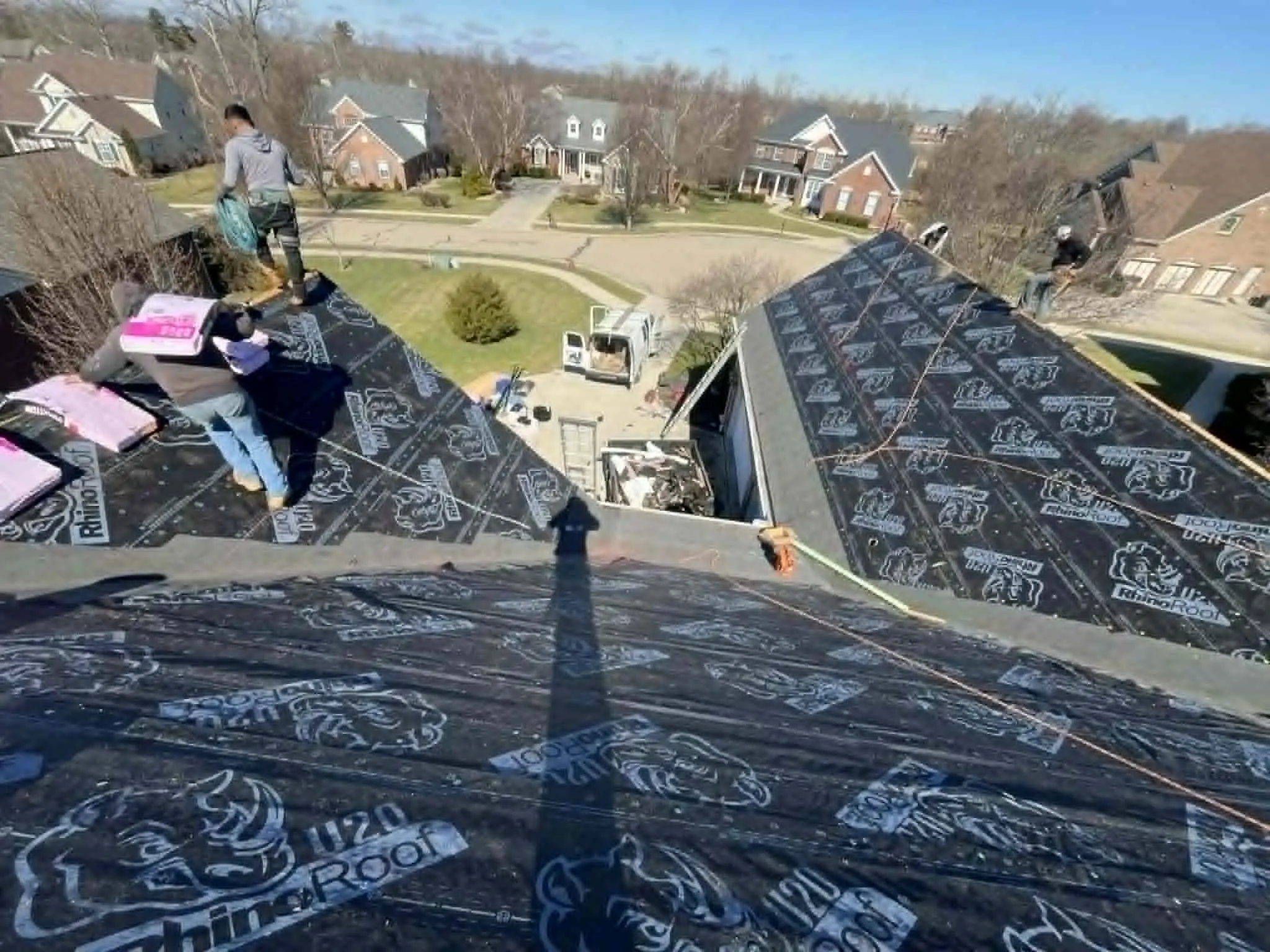 Roof section protected with a tarp between project phases to prevent water damage