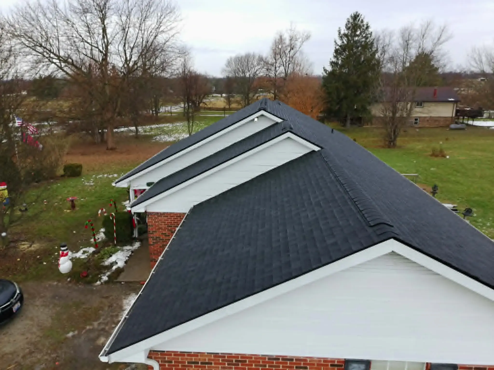 Roof edge with newly installed gutter runs and downspouts